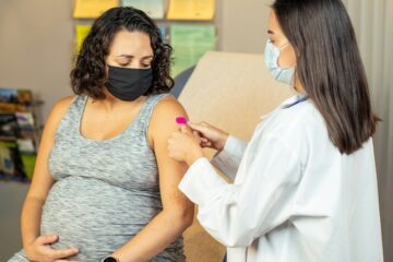 Donna incinta sottoposta a esame del sangue durante una visita prenatale