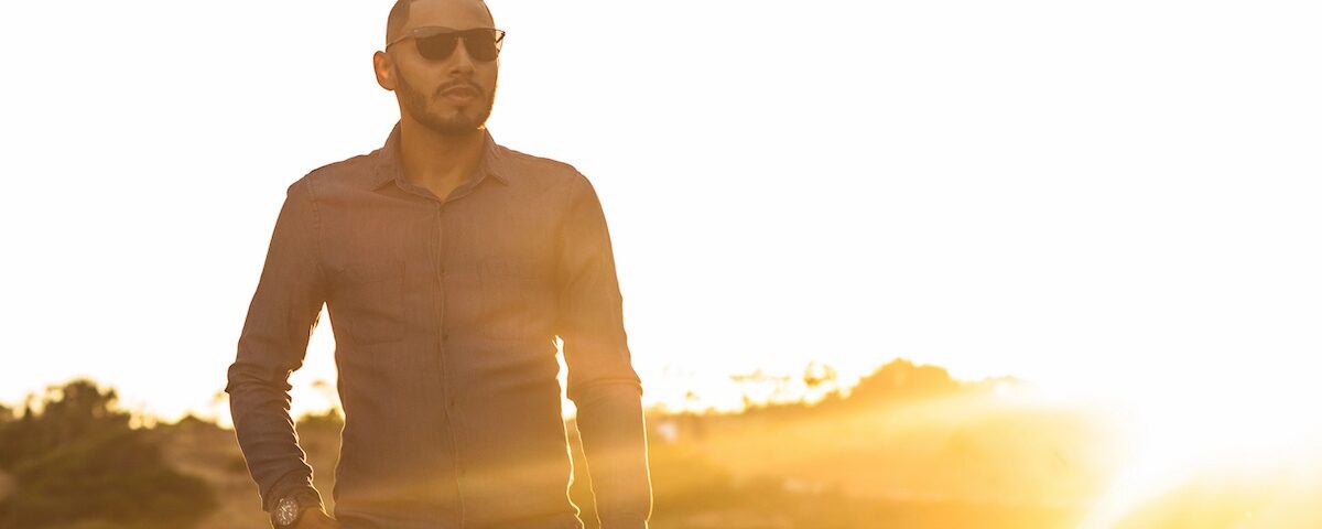 Uomo dallo sguardo intenso in ambiente naturale al tramonto